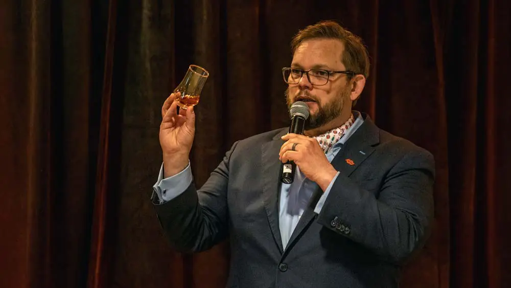 a man holding up his drink